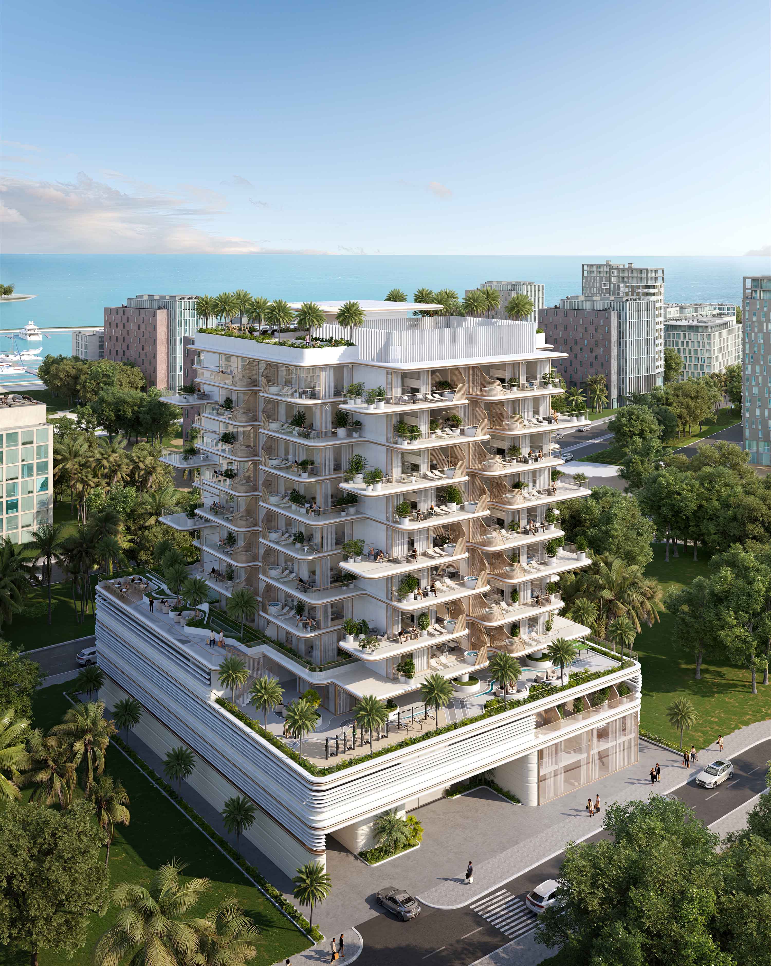 Sunset Bay By Imtiaz Modern multi-story building with tropical landscaping, balconies, and a view of the ocean in the background.